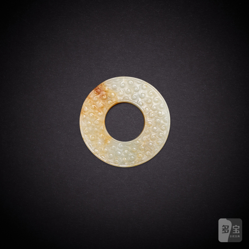 A white jade 'grain' disc, huan, Han dynasty | 漢 白玉穀紋環